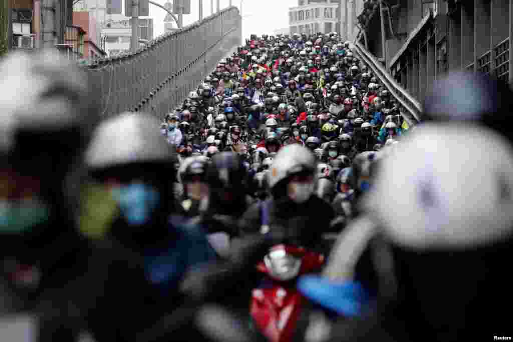 Commuters wear face masks to protect themselves from the coronavirus disease (COVID-19) spread during morning rush hour traffic in Taipei, Taiwan.