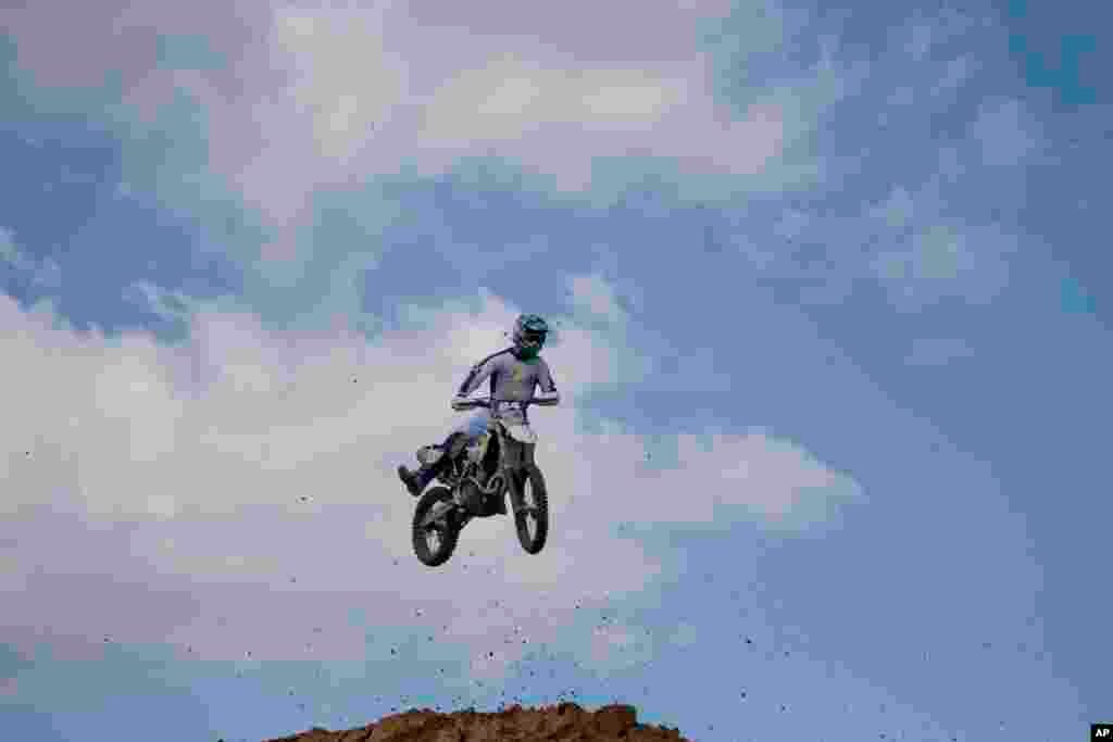 A rider jumps during a pre-race for the inauguration of the first official Motocross track the MX Wingate cross country race track near Netanya, Israel.