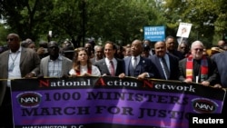 The Reverend Al Sharpton, third from right, leads a march to the Department of Justice during the 1,000 Ministers March for Justice in Washington, Aug. 28, 2017.
