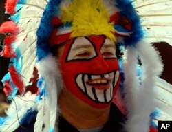FILE - Mike Margevicus, a fan of the Cleveland Indians Baseball team, waiting to enter Jacobs Field for the team's home opener, April 10, 1998, in Cleveland, Ohio. Nearby demonstrators protested the Indians mascot, Chief Wahoo, as racist.