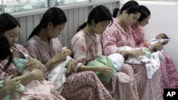 Mothers hold their newborn babies at Hanoi Maternity Hospital in Hanoi, Vietnam (File Photo)