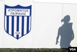A player walks past the changing rooms at the training grounds. Organization Earth has helped the team secure a field to play on, and intends to help cover the costs of going to play Greek teams, Nov. 11, 2016. (J. Owens/VOA)