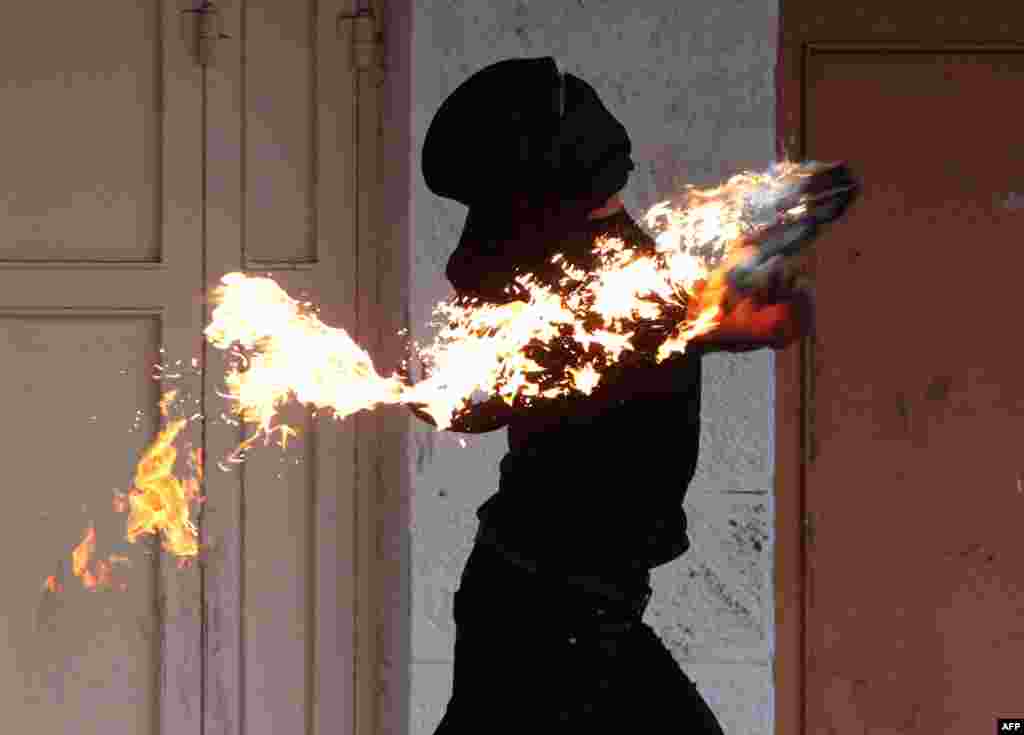 A PalestaA Palestinian demonstrator throws a petrol bomb towards Israeli border guards in the West Bank city of Hebron during a demonstration on November 27, 2013.inian demonstrator throws a petrol bomb towards Israeli border guards in the West Bank city