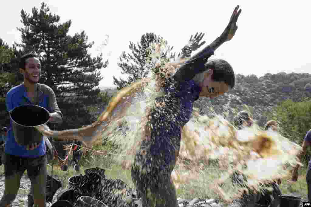 Participants compete in "The Mud Day Challenge", a 13-kilometer obstacles course in Beynes near Paris, France. 