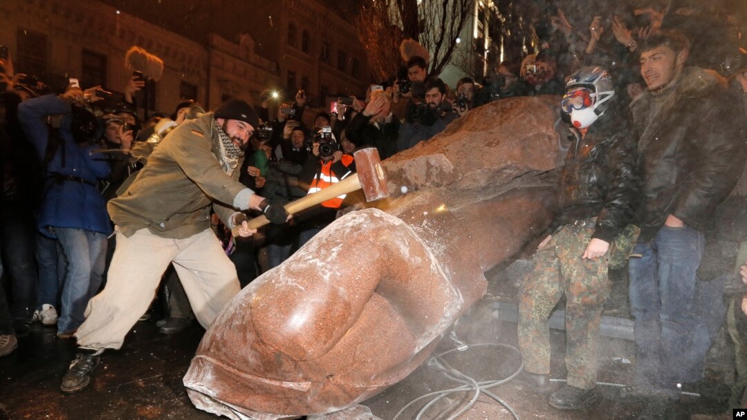 A man with a sledgehammer smashes the toppled statue of Vladimir Lenin in central Kyiv, December. 8, 2013.