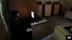 FILE - A man uses a computer at an internet cafe in Rawalpindi, Pakistan, Sept. 18, 2013. At least four secular activists and bloggers mysteriously went missing a week ago from different cities in Pakistan.