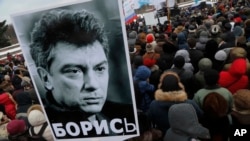 People gather in St. Petersburg, Russia, to commemorate the 2015 slaying of opposition leader Boris Nemtsov, Feb. 27, 2016.