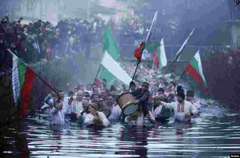 Bulgarian men dance in the icy waters of the Tundzha River during a celebration for Epiphany Day in the town of Kalofer, some 150 km (93 miles) east of Sofia, Bulgaria.