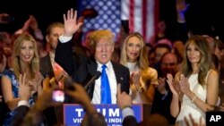 Republican presidential candidate Donald Trump is joined by his wife Melania, right, daughter Ivanka, left, as he speaks during a primary night news conference, Tuesday, May 3, 2016, in New York. (AP Photo/Mary Altaffer)