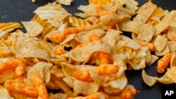 REPORT - A mix of salty snacks and potato chips is presented on a table at the Pittsburgh Market Square on February 7, 2012.