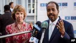 Somalia's President Hassan Sheikh Mohamud, right, gestures a he and European Union Foreign Policy Chief Catherine Ashton address the media prior to an EU Somalia conference in Brussels, Sept. 16, 2013.