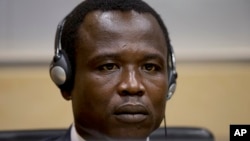 Dominic Ongwen, a Ugandan commander in warlord Joseph Kony's feared militia, waits for the judge to arrive as he made his first appearance at the International Criminal Court in The Hague, Netherlands, Jan. 26, 2015.