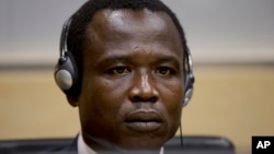 Dominic Ongwen, a Ugandan commander in warlord Joseph Kony's feared militia, waits for the judge to arrive as he made his first appearance at the International Criminal Court in The Hague, Netherlands, Jan. 26, 2015.