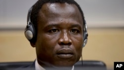 Dominic Ongwen, a Ugandan commander in warlord Joseph Kony's feared militia, waits for the judge to arrive as he made his first appearance at the International Criminal Court in The Hague, Netherlands, Jan. 26, 2015.