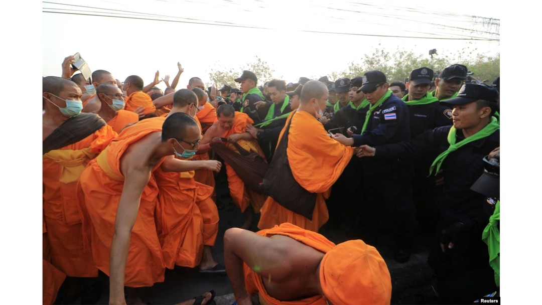 Dhammakaya temple Buddhist monks scuffle with police after they defied police orders to leave the temple grounds to enable police to seek out their former abbot in Pathum Thani, Thailand, Feb. 20, 2017.