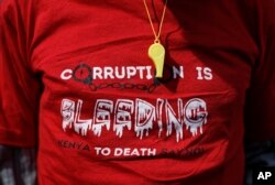 A whistle hangs over a protester's t-shirt during an anti-corruption demonstration by hundreds of protesters who marched to the Parliament and Supreme Court in downtown Nairobi, Kenya, May 31, 2018.