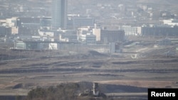 A North Korean guard post (bottom, C) is pictured from the truce village of Panmunjom in the demilitarized zone separating the two Koreas in Paju, north of Seoul, as the Kaesong inter-Korean industrial complex is seen in the background. (2011 File)