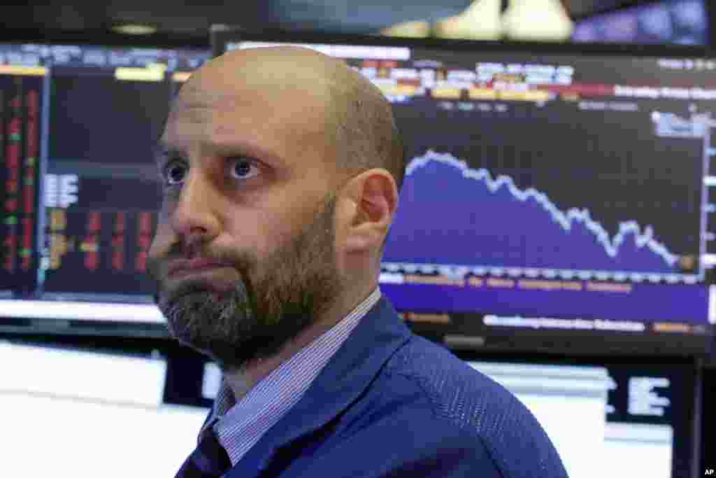 Specialist Meric Greenbaum works on the floor of the New York Stock Exchange.