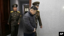 FILE - Hyeon Soo Lim, center, who pastors the Light Korean Presbyterian Church in Toronto, is escorted to his sentencing in Pyongyang, North Korea.