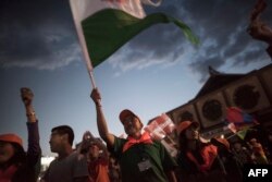 A supporter waves a flag during a rally for presidential candidate Ganbaatar Sainkhuu in Ulaanbaatar, Mongolia, June 23, 2017.