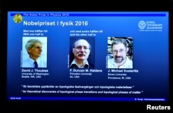 A screen showing pictures of the winners of the 2016 Nobel Prize for Physics during a news conference by the Royal Swedish Academy of Sciences in Stockholm, Sweden, Oct. 4, 2016.