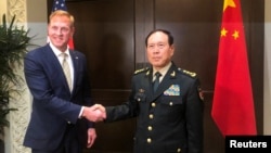 Acting U.S. Defense Secretary Patrick Shanahan and Chinese Defense Minister Wei Fenghe meet before the start of their meeting in Singapore on the sidelines of the Shangri-La dialogue, May 31, 2019. 