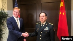 Acting U.S. Defense Secretary Patrick Shanahan and Chinese Defense Minister Wei Fenghe meet before the start of their meeting in Singapore on the sidelines of the Shangri-La dialogue, May 31, 2019.