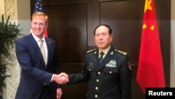 Acting U.S. Defense Secretary Patrick Shanahan and Chinese Defense Minister Wei Fenghe meet before the start of their meeting in Singapore on the sidelines of the Shangri-La dialogue, May 31, 2019. 