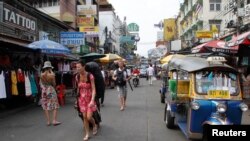 Tourists walk along Khao San road in Bangkok. Thai authorities have arrested a Lebanese suspect after being warned by Israel of a possible attack in Bangkok.