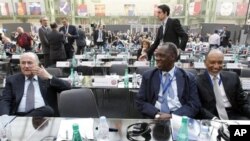 FIFA president Sepp Blatter, left, and Mohamed bin Hammam of Qatar, president of the Asian Football Confederation, right, take a break as Confederation of African Football President Issa Hayatou, center, looks on, March 22, 2011 (file photo).