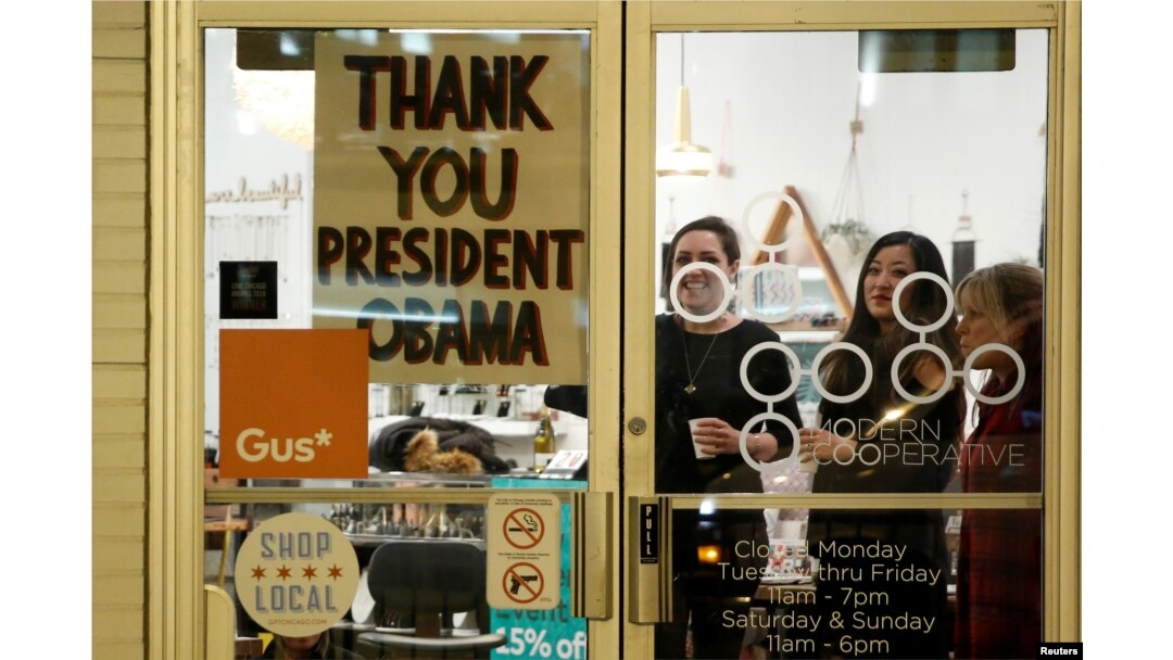 A shop has a sign in the window reading thank you to U.S. President Barack Obama, who was making a stop nearby on his way to deliver his farewell address in Chicago, Ill., Jan. 10, 2017.