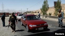 Afghan security forces keep watch at a checkpoint on the Ghazni highway, in Maidan Shar, the capital of Wardak province, Afghanistan, Aug. 12, 2018.