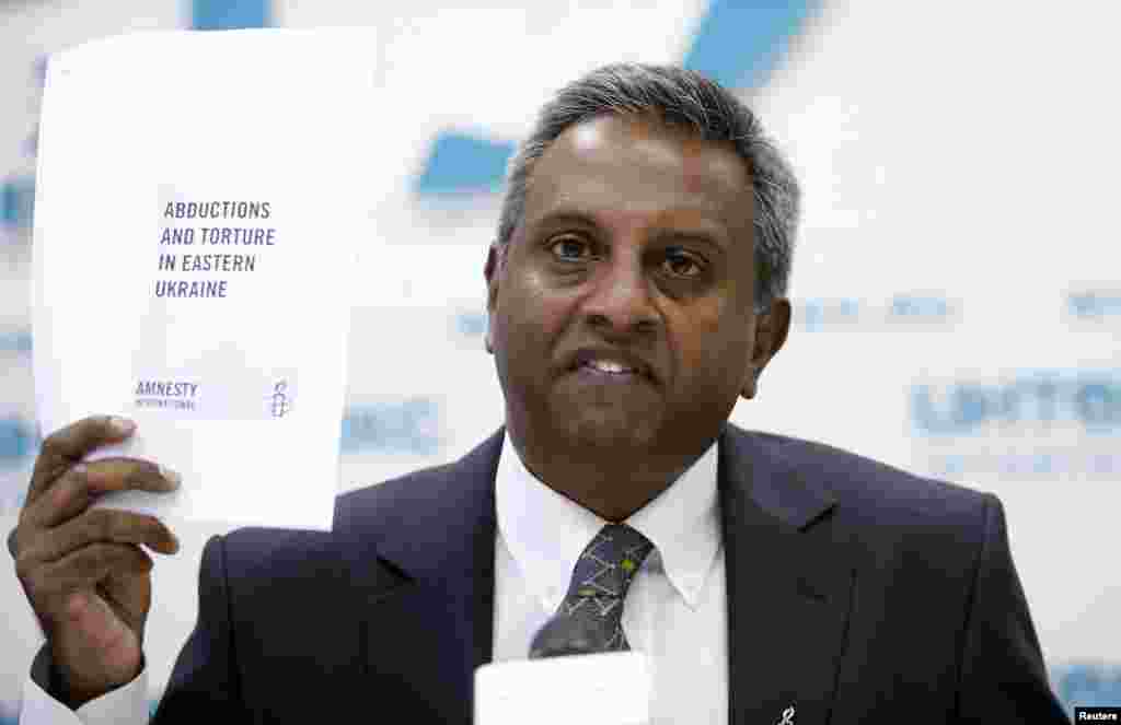 Amnesty International's Secretary General Salil Shetty speaks during a news conference in Moscow, Sept. 10, 2014.