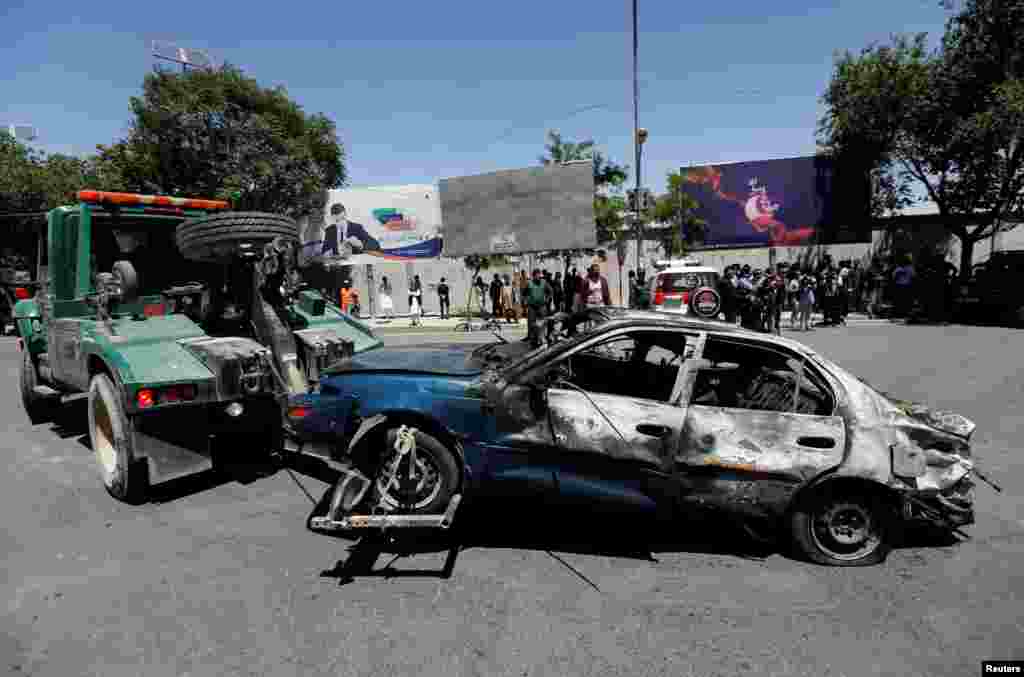 A damaged car is moved away after a blast in Kabul, Afghanistan May 31, 2017. 