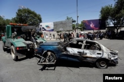 A damaged car is moved away after a blast in Kabul, Afghanistan May 31, 2017.