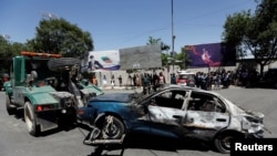 A damaged car is moved away after a blast in Kabul, Afghanistan May 31, 2017. 