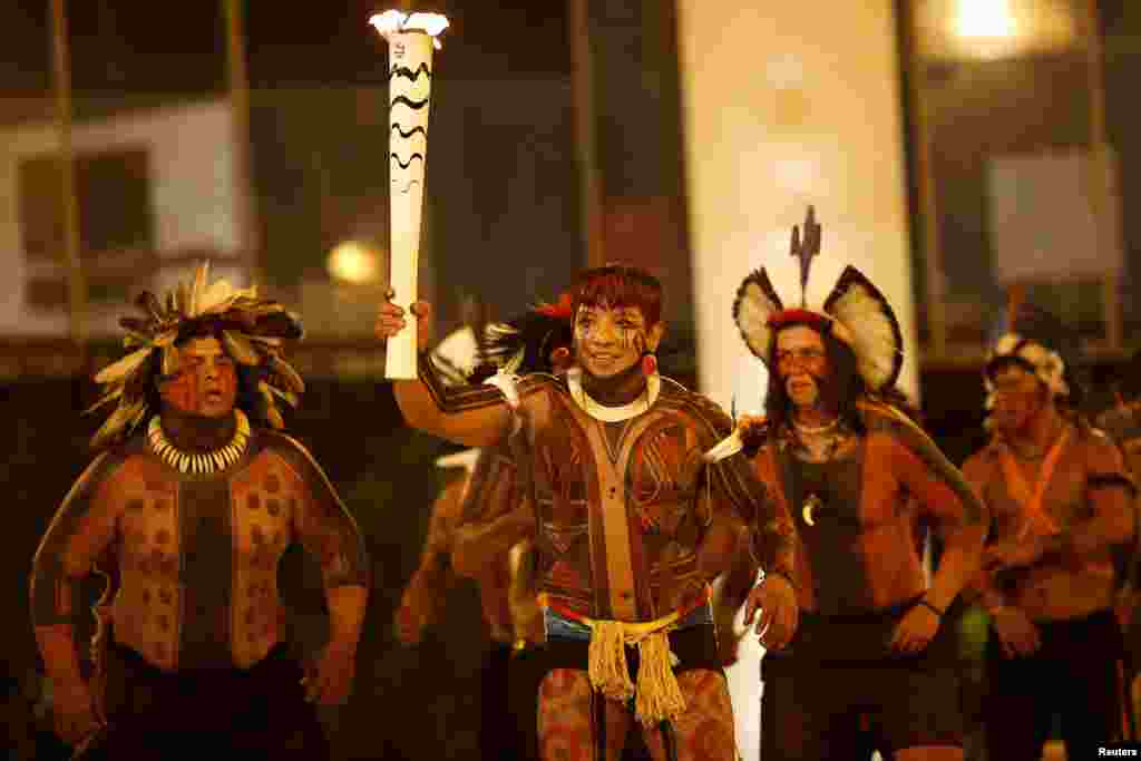 Athlete Kamukaika Lappa of the Yawalapiti ethnic group takes part in the Olympic Flame torch relay in Brasilia, Brazil, May 3, 2016.