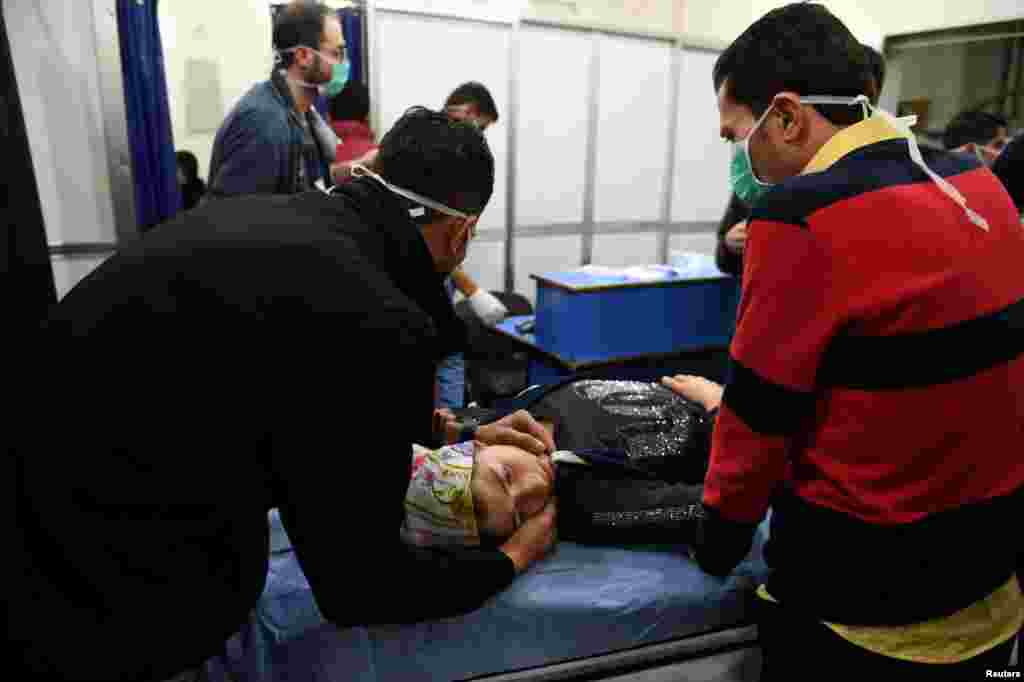 A woman lies on a stretcher inside a hospital after what the Syrian state media said was a suspected toxic gas attack in Aleppo, Nov. 24, 2018.