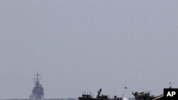 Israeli naval vessels (L) arrive at the port of Ashdod in southern Israel, 05 Jun 2010