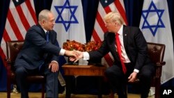 President Donald Trump shakes hands with Israeli Prime Minister Benjamin Netanyahu during a meeting at the Palace Hotel during the United Nations General Assembly in New York, Sept. 18, 2017. 
