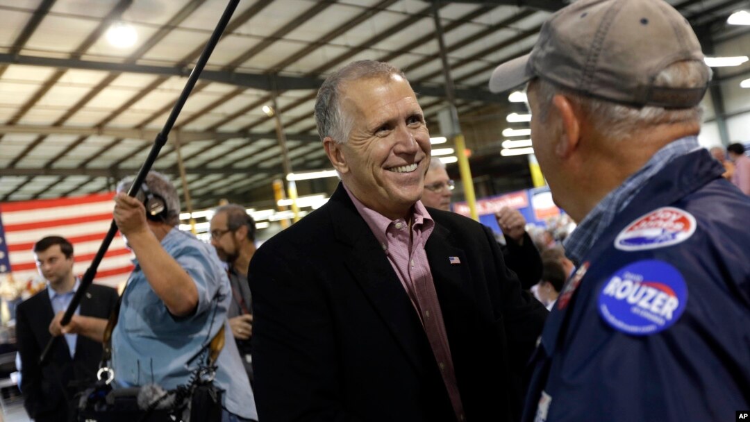 U.S. Senate candidate and Speaker of the N.C. House Thom Tillis speaks with a supporter during a conservative rally in Smithfield, N.C., Oct. 24, 2014.