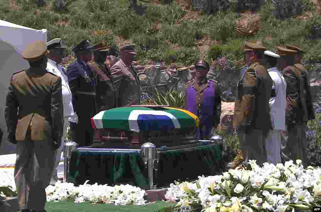 A screengrab from the South African Broadcasting Corporation shows members of the South African armed forces standing around the coffin of Nelson Mandela before it is lowered into the ground, Dec. 15, 2013.