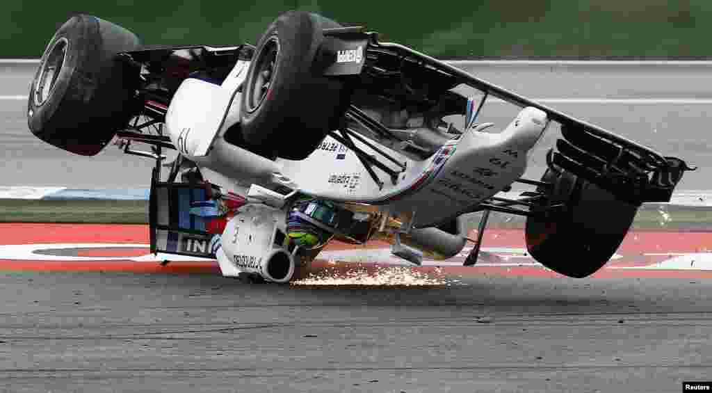 Williams Formula One driver Felipe Massa of Brazil crashes with his car in the first corner after the start of the German F1 Grand Prix at the Hockenheim racing circui.