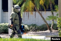 A member of the Broward County Sheriff's Office bomb squad walks to the building where U.S. Rep. Debbie Wasserman Schultz's office is housed in Sunrise, Florida, Oct. 24, 2018.