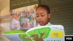 Karobo Mokhere,8, reads to her class at Thabo-Tshehlo in Soweto. Just a few months ago, she struggled to read a sentence. (D. Taylor/VOA)