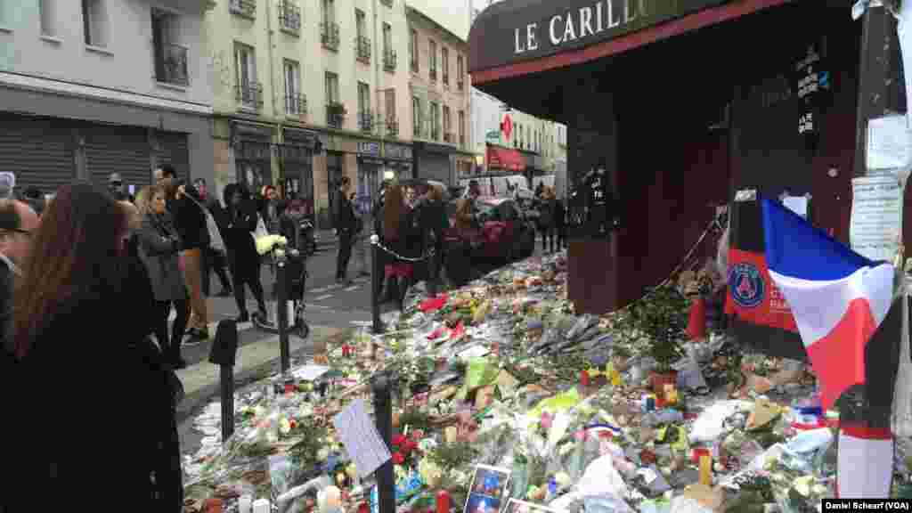 Mourners gather near Le Petit Cambodge and Le Carillon, which were the first restaurants hit in the multiple attacks across Paris Friday that left more than 120 people dead and hundreds wounded, Nov. 17, 2015.