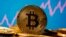 FILE - A representation of virtual currency Bitcoin is seen in front of a stock graph in this illustration taken November 19, 2020. (REUTERS/Dado Ruvic/Illustration/File Photo)