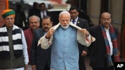 FILE - Indian Prime Minister Narendra Modi, center, arrives with his cabinet colleagues on the opening day of the budget session of the Indian Parliament, in New Delhi, Jan. 31, 2019.
