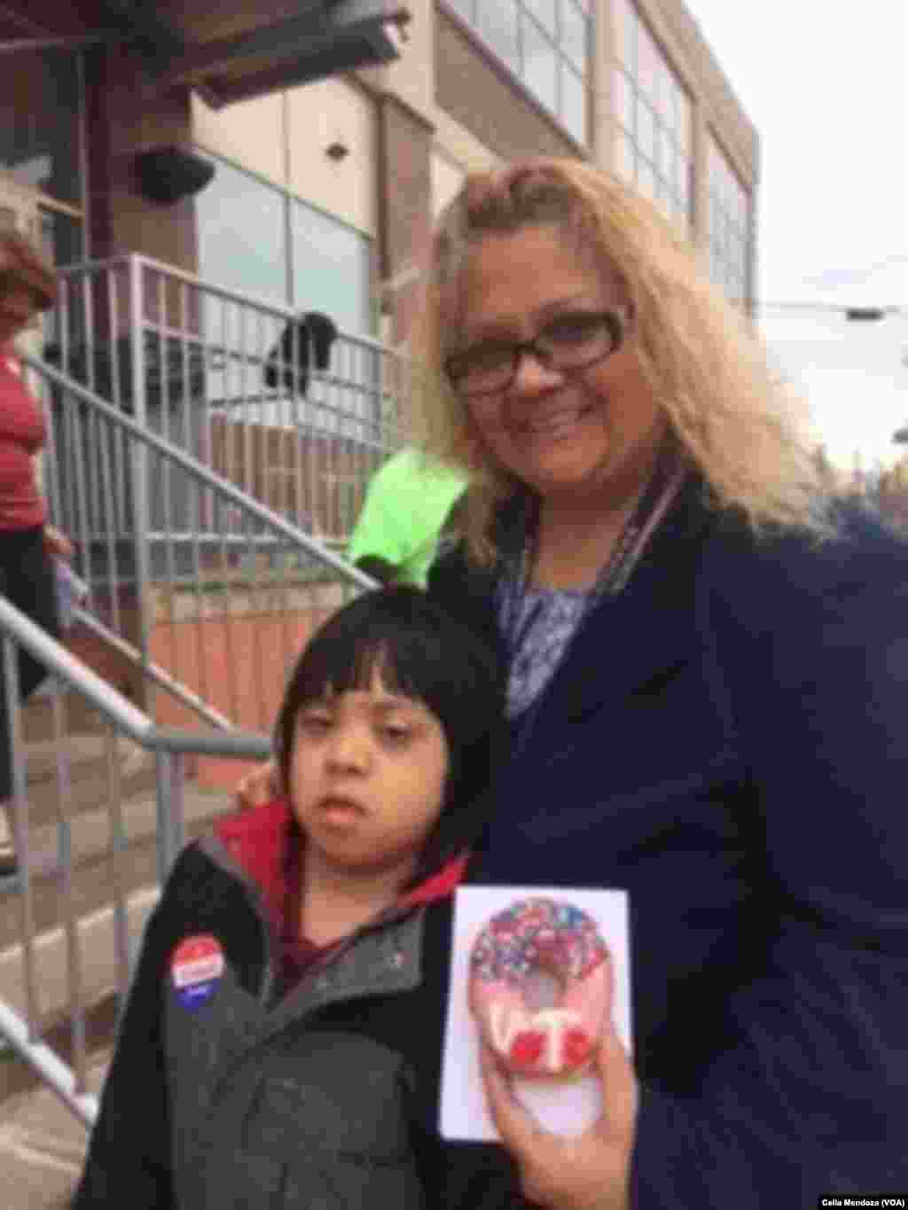 Luisa Baerga leaves her polling station with her 9-year-old son Javier, who was given a "vote" donut, Philadelphia, Pa., April 26, 2016.