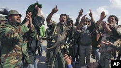 Libyan rebels celebrate as they hear about air strikes at front line near Brega, Libya, April 1, 2011